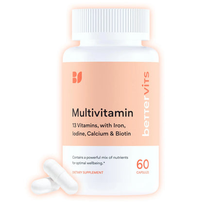 Multivitamin supplement bottle with white capsules on a light pink background