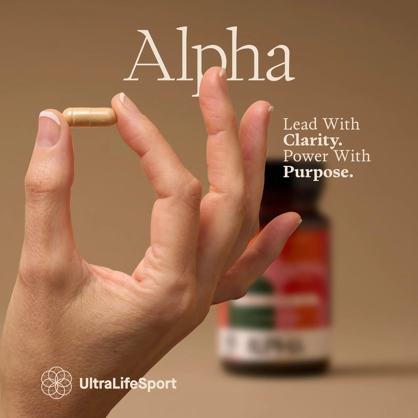 Hand holding a supplement capsule with 'Alpha' branding and UltraLifeSport logo.